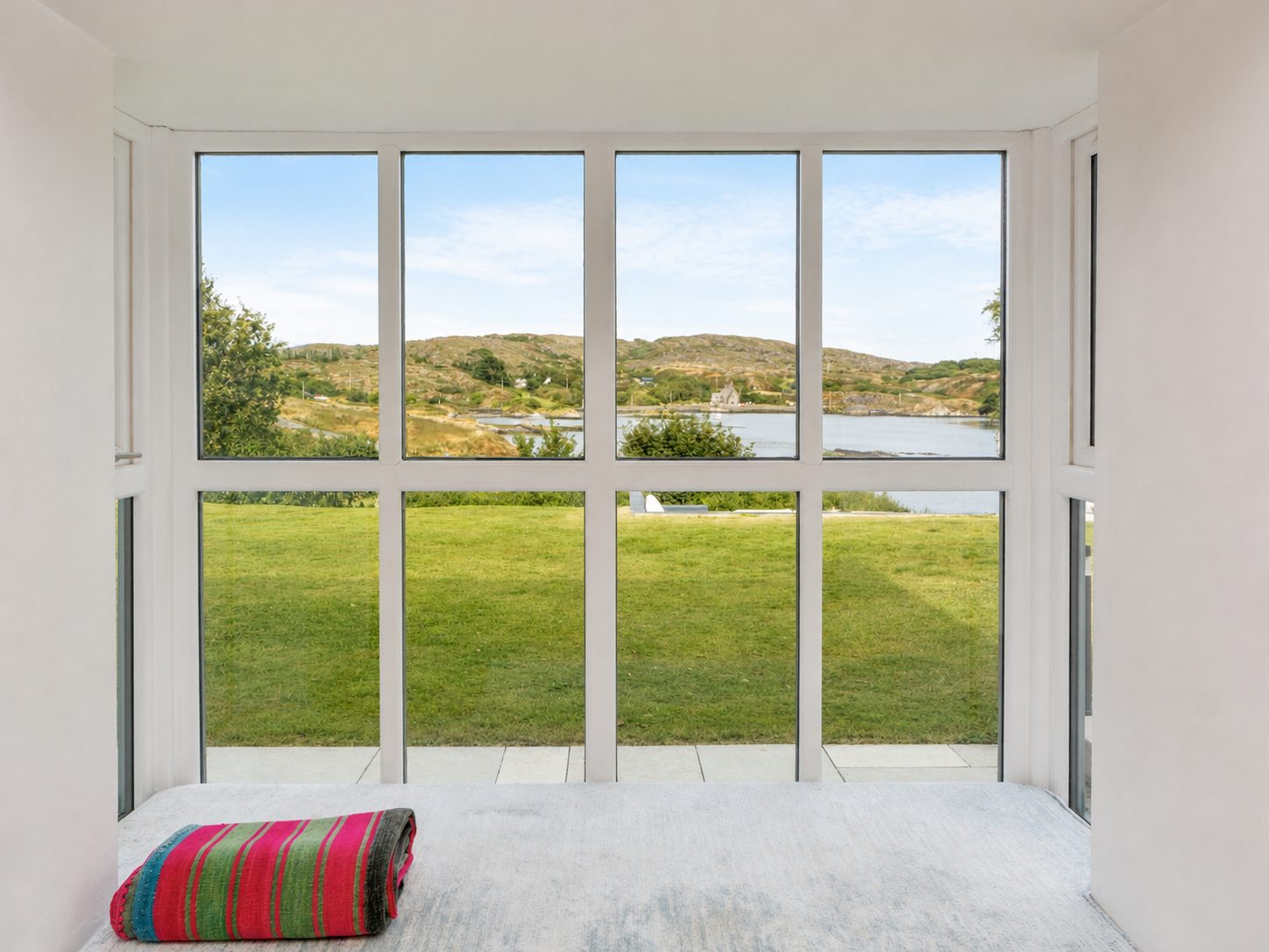 View through the front window across the lawn to Toormore Cove