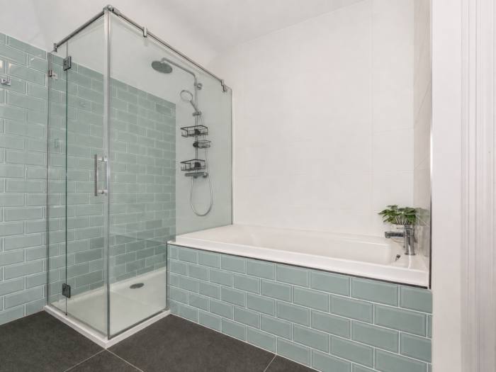 Bathroom with glass shower enclosure and bath