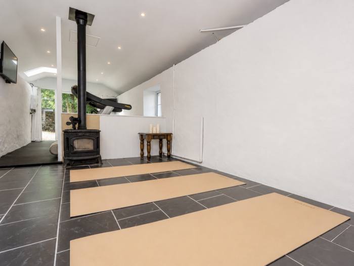 Wellness studio with professional rubber flooring and wood stove